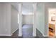 Hallway with clean gray walls, columns and access to the main bedroom and bathroom at 1523 Fallen Leaf Dr, Marietta, GA 30064