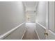 Hallway with neutral paint leads to a large bedroom with arched windows and a ceiling fan at 1523 Fallen Leaf Dr, Marietta, GA 30064