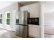 Updated kitchen featuring stainless steel appliances, white cabinets, and modern backsplash at 1523 Fallen Leaf Dr, Marietta, GA 30064