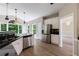 Bright kitchen with stainless appliances, white cabinets, and laminate flooring with a view to the living room at 1523 Fallen Leaf Dr, Marietta, GA 30064
