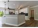 Modern kitchen design with white cabinetry, stainless steel appliances, black countertops, and wood laminate flooring at 1523 Fallen Leaf Dr, Marietta, GA 30064
