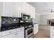 Updated kitchen featuring granite counters, stainless appliances, and bright white cabinets at 1523 Fallen Leaf Dr, Marietta, GA 30064