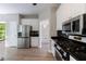 Stylish kitchen showcasing modern appliances, white cabinetry, and laminate flooring with an open design at 1523 Fallen Leaf Dr, Marietta, GA 30064