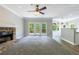 Living room area has stone fireplace, carpeting and doors to a deck at 1523 Fallen Leaf Dr, Marietta, GA 30064