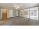 Spacious living room featuring neutral paint, plush carpet, and three different entryways at 1523 Fallen Leaf Dr, Marietta, GA 30064