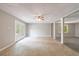 Living room featuring tiled and carpeted sections, columns, and natural lighting at 1523 Fallen Leaf Dr, Marietta, GA 30064