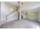 Spacious living room with carpet, fireplace, chandelier and open stairway at 1523 Fallen Leaf Dr, Marietta, GA 30064