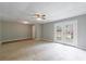 Living room featuring neutral paint, stone-look tile floor, and glass paneled patio doors at 1523 Fallen Leaf Dr, Marietta, GA 30064
