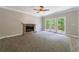 Bright living room features doors to an outdoor deck, neutral paint, and carpeting at 1523 Fallen Leaf Dr, Marietta, GA 30064