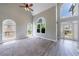 Bright living room with two-story windows, plush carpet, and entry to backyard at 1523 Fallen Leaf Dr, Marietta, GA 30064