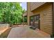 Exterior patio with brown siding, a full glass door, and partial view of the backyard at 1523 Fallen Leaf Dr, Marietta, GA 30064