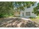 Backyard features a patio with lush green trees, creating a private outdoor space at 1528 Rogers Crossing Dr, Lithonia, GA 30058