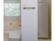 Bathroom featuring a soaking tub, frosted shower door, and bright natural light at 1528 Rogers Crossing Dr, Lithonia, GA 30058