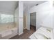 Bright bathroom featuring a soaking tub, walk-in shower, and double sink vanity at 1528 Rogers Crossing Dr, Lithonia, GA 30058