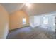 Spacious bedroom featuring vaulted ceilings, two windows, carpet flooring and neutral colored walls at 1528 Rogers Crossing Dr, Lithonia, GA 30058