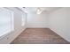 A bright bedroom with wood floors, white walls and two windows at 1528 Rogers Crossing Dr, Lithonia, GA 30058