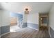 A cozy dining room featuring wood floors, a modern light fixture, and open access at 1528 Rogers Crossing Dr, Lithonia, GA 30058