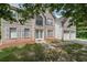 Two-story home with an attached two car garage and a beautifully landscaped front yard at 1528 Rogers Crossing Dr, Lithonia, GA 30058