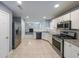 This kitchen features stainless steel appliances, granite countertops, and tiled floors at 1528 Rogers Crossing Dr, Lithonia, GA 30058