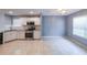 Bright kitchen features granite counters, stainless steel appliances, and tile flooring at 1528 Rogers Crossing Dr, Lithonia, GA 30058
