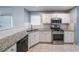 This kitchen features stainless steel appliances, granite countertops, and tiled floors at 1528 Rogers Crossing Dr, Lithonia, GA 30058