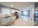 Bright kitchen features granite counters, stainless steel appliances, and tile flooring at 1528 Rogers Crossing Dr, Lithonia, GA 30058