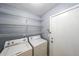 The laundry room includes a washer, dryer, and plenty of shelving for storage at 1528 Rogers Crossing Dr, Lithonia, GA 30058