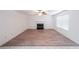 Spacious living room featuring wood floors, a fireplace, a window, and neutral walls at 1528 Rogers Crossing Dr, Lithonia, GA 30058