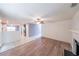 Living room featuring wood floors, a fireplace, and open access to other rooms at 1528 Rogers Crossing Dr, Lithonia, GA 30058