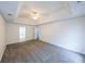 Spacious main bedroom featuring a tray ceiling, neutral walls and carpet flooring at 1528 Rogers Crossing Dr, Lithonia, GA 30058