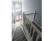 Grand staircase with white banister and carpeted steps leading to the upper level at 1528 Rogers Crossing Dr, Lithonia, GA 30058