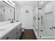 Modern bathroom with dual sink vanity and glass-enclosed shower featuring dark fixtures at 202 Windcroft Nw Ct, Acworth, GA 30101