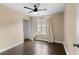 Neutral bedroom featuring modern ceiling fan, wood floors and a window at 202 Windcroft Nw Ct, Acworth, GA 30101