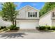 Charming two-story home with attached two-car garage, beautiful landscaping and neutral colored siding at 202 Windcroft Nw Ct, Acworth, GA 30101