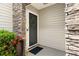 Inviting front door with decorative wreath, stone accents and landscaped surroundings at 202 Windcroft Nw Ct, Acworth, GA 30101