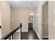 Upstairs hallway with wood floors leading to bathroom at 202 Windcroft Nw Ct, Acworth, GA 30101
