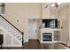 Comfortable living room with a fireplace, built in shelves, and a staircase at 202 Windcroft Nw Ct, Acworth, GA 30101