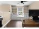 Well-lit office space with built-in shelves, laminate flooring, and a ceiling fan at 202 Windcroft Nw Ct, Acworth, GA 30101