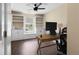 Well-lit office space with built-in shelves, laminate flooring and a ceiling fan at 202 Windcroft Nw Ct, Acworth, GA 30101
