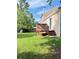 Backyard featuring a wooden deck, complemented by lush greenery at 2115 Charter Ln, Lithonia, GA 30058