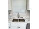 The kitchen sink has stainless steel appliances and modern finishes at 2115 Charter Ln, Lithonia, GA 30058
