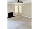 Open living room with a fireplace and abundant natural light from the large windows at 2115 Charter Ln, Lithonia, GA 30058