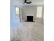 Spacious living room with a fireplace and ceiling fan, offering a cozy atmosphere at 2115 Charter Ln, Lithonia, GA 30058