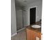 Modern bathroom featuring granite countertops, a glass shower, and a walk-in closet at 6121 Joybrook Rd, Johns Creek, GA 30097