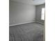 Large bedroom with neutral paint, plush carpet, and a window at 6121 Joybrook Rd, Johns Creek, GA 30097
