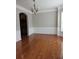 Elegant dining room with hardwood floors, wainscoting, and a modern chandelier at 6121 Joybrook Rd, Johns Creek, GA 30097