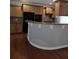 Kitchen featuring a breakfast bar, dark appliances, and wood cabinetry at 6121 Joybrook Rd, Johns Creek, GA 30097