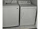 Modern laundry room featuring white washer and dryer at 6121 Joybrook Rd, Johns Creek, GA 30097