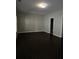 Large living room with dark wood floors and a window at 6121 Joybrook Rd, Johns Creek, GA 30097