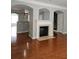 Beautiful living room featuring hardwood floors, fireplace and views of the kitchen at 6121 Joybrook Rd, Johns Creek, GA 30097